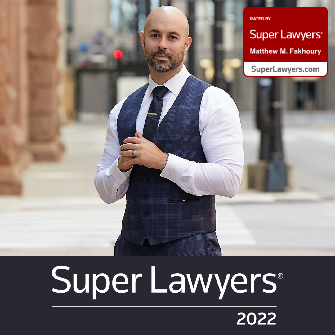 Chicago lawyer Matt Fakhoury standing on a sidewalk with the Super Lawyers 2021 rating logo along with additional URLs for sites on top of slightly transparent gray block. Sites are: ILDefense.com, XpungeChicago.com, and DomesticDefenseChicago.com.